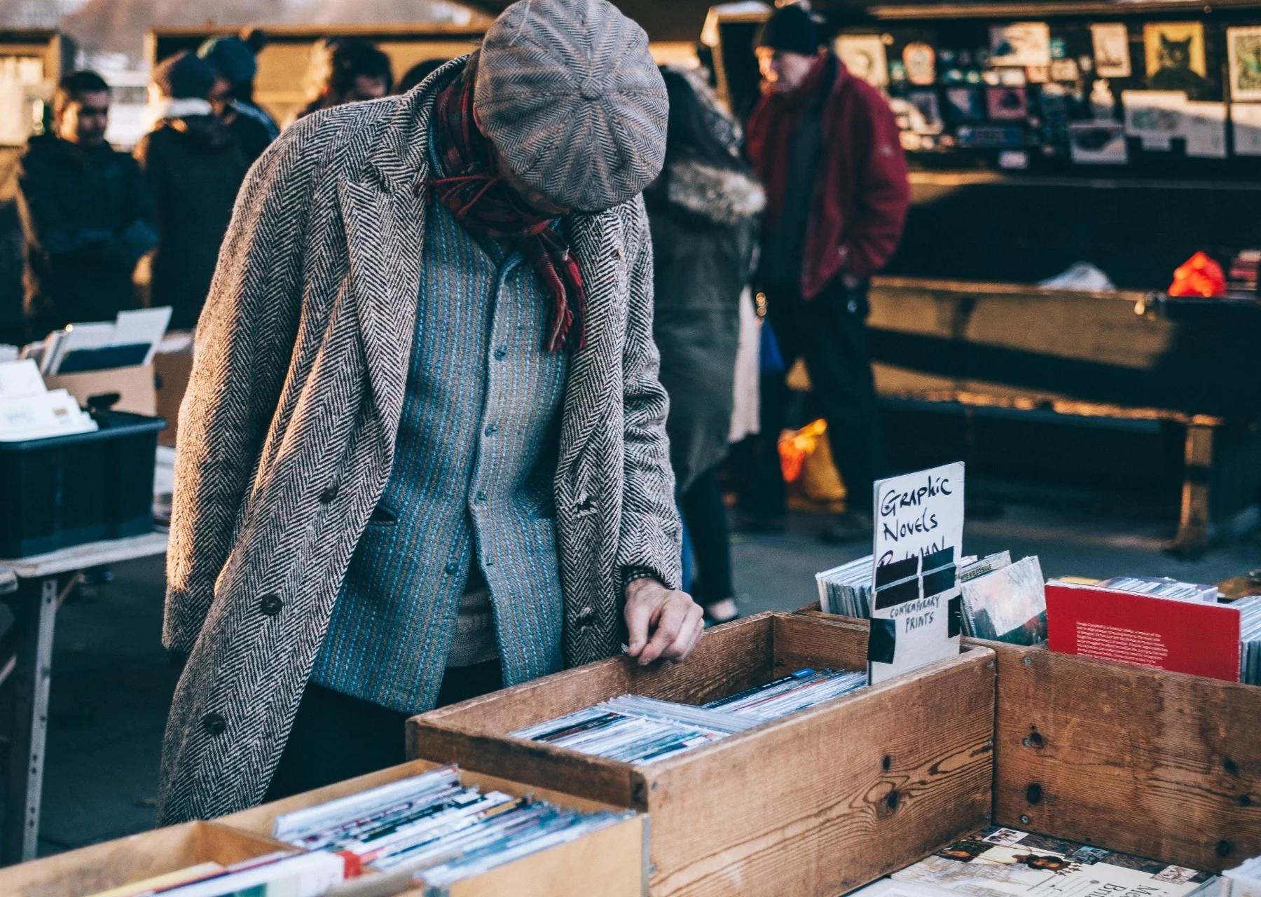 A shopper browsing records at an open-air market